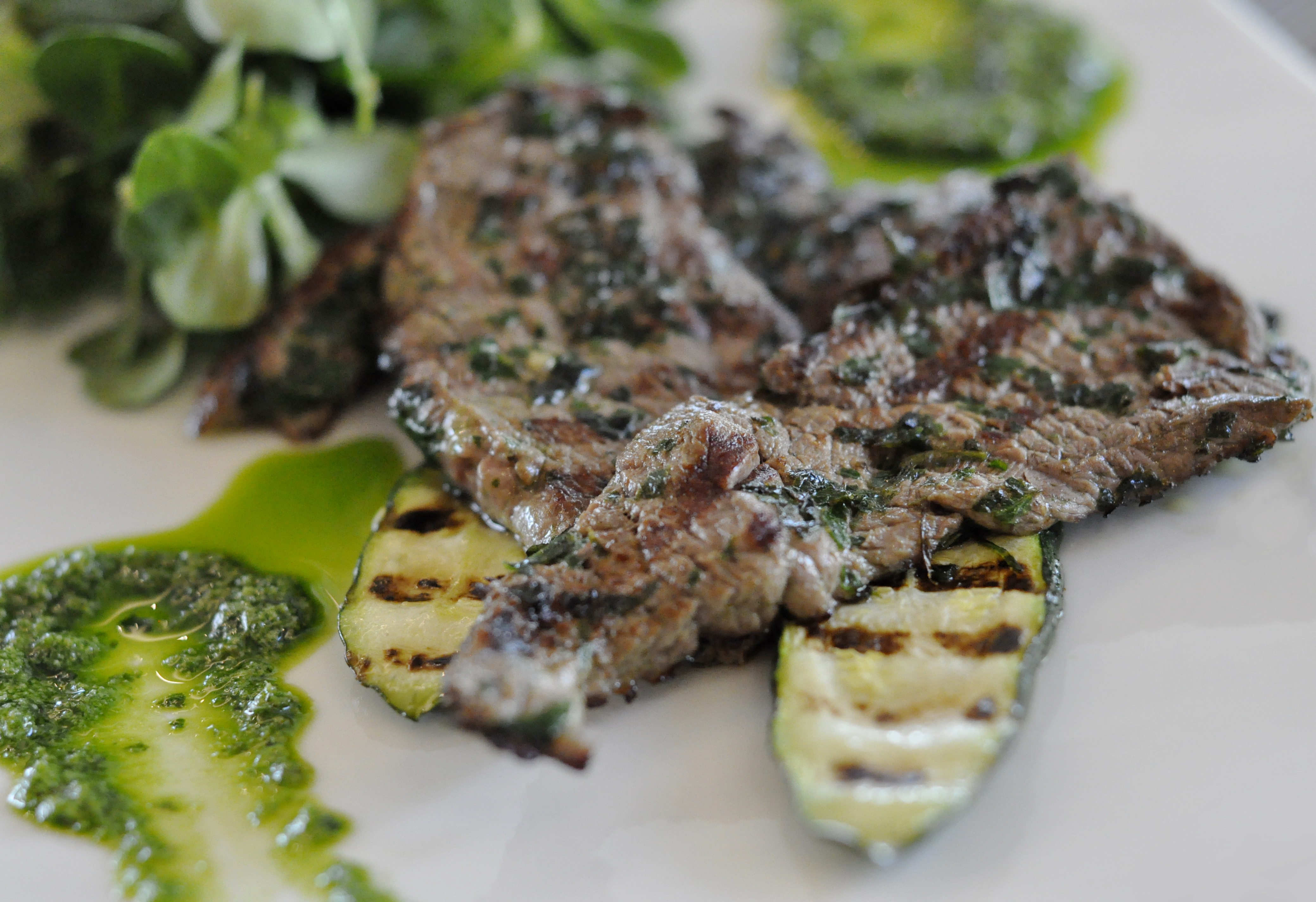 Grilled horse meat with grilled zucchini and green sauce